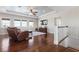 Spacious living room with hardwood floors, large windows, a ceiling fan and comfortable seating area at 718 Key Royale Dr, Holmes Beach, FL 34217
