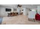 Large living area with tile flooring, dining set, and multiple doorways at 718 Key Royale Dr, Holmes Beach, FL 34217