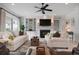 Spacious living room includes a fireplace, a flat screen TV, and access to the outdoors at 718 Key Royale Dr, Holmes Beach, FL 34217