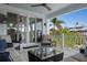 Covered patio with neutral furniture, ceiling fan, and sliding doors to the interior at 718 Key Royale Dr, Holmes Beach, FL 34217
