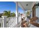 Charming covered porch with comfortable seating and a water view at 718 Key Royale Dr, Holmes Beach, FL 34217