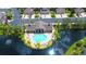 Community pool and clubhouse surrounded by lush landscaping at 7946 Tybee Ct, University Park, FL 34201
