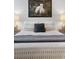 Well-lit bedroom with a bed and patterned bedding at 7946 Tybee Ct, University Park, FL 34201