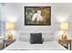 Serene bedroom with bed and nightstands, featuring calming artwork at 7946 Tybee Ct, University Park, FL 34201