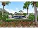 Community entrance with landscaping and signage at 7946 Tybee Ct, University Park, FL 34201