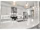 Gourmet kitchen featuring white cabinets, quartz countertops, and stainless steel appliances at 7946 Tybee Ct, University Park, FL 34201