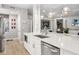 Modern white kitchen with stainless steel appliances and quartz countertops at 7946 Tybee Ct, University Park, FL 34201