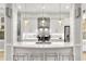 Modern white kitchen with quartz countertops, stainless steel appliances, and herringbone backsplash at 7946 Tybee Ct, University Park, FL 34201