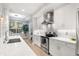 White kitchen with stainless steel appliances and herringbone backsplash at 7946 Tybee Ct, University Park, FL 34201
