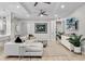 Spacious living room with light colored sectional sofa, large TV, and plenty of natural light at 7946 Tybee Ct, University Park, FL 34201