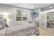 Main bedroom with sliding doors to the patio, comfortable seating, and TV at 7946 Tybee Ct, University Park, FL 34201