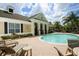 Community pool with adjacent patio and lounge chairs at 7946 Tybee Ct, University Park, FL 34201