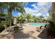 Relaxing pool area with patio furniture and lush landscaping at 7946 Tybee Ct, University Park, FL 34201