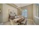 Formal dining room with wood table, neutral decor, and window at 8122 Lone Tree Gln, Lakewood Ranch, FL 34202