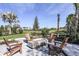 Outdoor fire pit with seating and lush landscaping at 8144 Moonbeam Ave, Sarasota, FL 34241