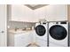 Laundry room with white cabinets and modern appliances at 8144 Moonbeam Ave, Sarasota, FL 34241