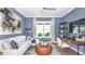 Home office with blue shiplap walls, white sofa, and built in desk at 8144 Moonbeam Ave, Sarasota, FL 34241