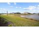Landscaped backyard with lake view at 8528 Beechlake Ct, Sarasota, FL 34240