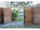 Wooden gate opens to the side yard at 904 Hunter Ln, Tarpon Springs, FL 34689