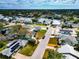 Aerial view of a house and neighborhood, showcasing waterfront property and lush landscaping at 905 69Th Nw St, Bradenton, FL 34209