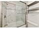 Clean bathroom with a bathtub, shower, and marble tile at 905 69Th Nw St, Bradenton, FL 34209