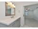 Modern bathroom with gray vanity and large mirror at 905 69Th Nw St, Bradenton, FL 34209