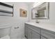 Bathroom with gray vanity, white countertop and a large mirror at 905 69Th Nw St, Bradenton, FL 34209