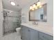 Updated bathroom with gray vanity, quartz countertop and a walk-in shower at 905 69Th Nw St, Bradenton, FL 34209