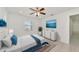 Bright bedroom with a ceiling fan, large window and hardwood floors at 905 69Th Nw St, Bradenton, FL 34209