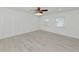 Bright bedroom with wood-look tile floors and ceiling fan at 905 69Th Nw St, Bradenton, FL 34209