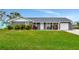 Gray house with white trim, landscaping, and a two-car garage at 905 69Th Nw St, Bradenton, FL 34209