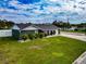 Single-story home with gray exterior, landscaping, and a spacious lawn at 905 69Th Nw St, Bradenton, FL 34209