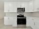 Modern kitchen featuring white cabinets and stainless steel appliances at 905 69Th Nw St, Bradenton, FL 34209