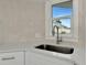 Modern kitchen sink with stainless steel fixtures and white quartz countertop at 905 69Th Nw St, Bradenton, FL 34209