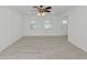 Bright living room featuring wood-look tile floors and ceiling fan at 905 69Th Nw St, Bradenton, FL 34209