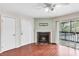 Living room with fireplace and sliding glass doors to balcony at 9100 Dr Martin Luther King Jr N St # 1302, St Petersburg, FL 33702