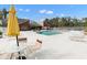 Community pool with lounge chairs and patio furniture at 9100 Dr Martin Luther King Jr N St # 1302, St Petersburg, FL 33702