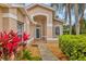 Welcoming front entrance with walkway, landscaping, and tiled porch at 9414 Forest Hills Cir, Sarasota, FL 34238