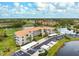 Aerial view of condo building showcasing its architecture and parking at 9610 Club South Cir # 4301, Sarasota, FL 34238