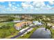 Aerial view of condo community with pool, tennis courts, and lush landscaping at 9610 Club South Cir # 4301, Sarasota, FL 34238