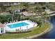 Community pool with lounge chairs and umbrellas at 1000 San Lino Cir # 1032, Venice, FL 34292