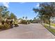 Gated community entrance with brick pavers and lush landscaping at 1000 San Lino Cir # 1032, Venice, FL 34292