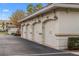 Four-car garage with white doors and adjacent parking at 1000 San Lino Cir # 1032, Venice, FL 34292