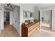 Bright hallway with dresser and views into other rooms at 1000 San Lino Cir # 1032, Venice, FL 34292