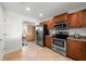 View of kitchen with stainless steel appliances and wood cabinets at 1000 San Lino Cir # 1032, Venice, FL 34292