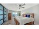 Bedroom with a comfortable bed, chest of drawers, balcony, and breathtaking water views at 101 S Gulfstream Ave # 16J, Sarasota, FL 34236