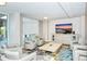 Bright living room featuring contemporary furnishings, including a large flat screen television and modern furniture at 101 S Gulfstream Ave # 16J, Sarasota, FL 34236