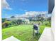 Grass backyard with grill and view of neighborhood at 10155 Hallendale Dr, Port Charlotte, FL 33981