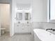 Elegant bathroom featuring a freestanding tub and double vanity at 10155 Hallendale Dr, Port Charlotte, FL 33981