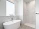 Spa-like bathroom with a soaking tub and walk-in shower at 10155 Hallendale Dr, Port Charlotte, FL 33981